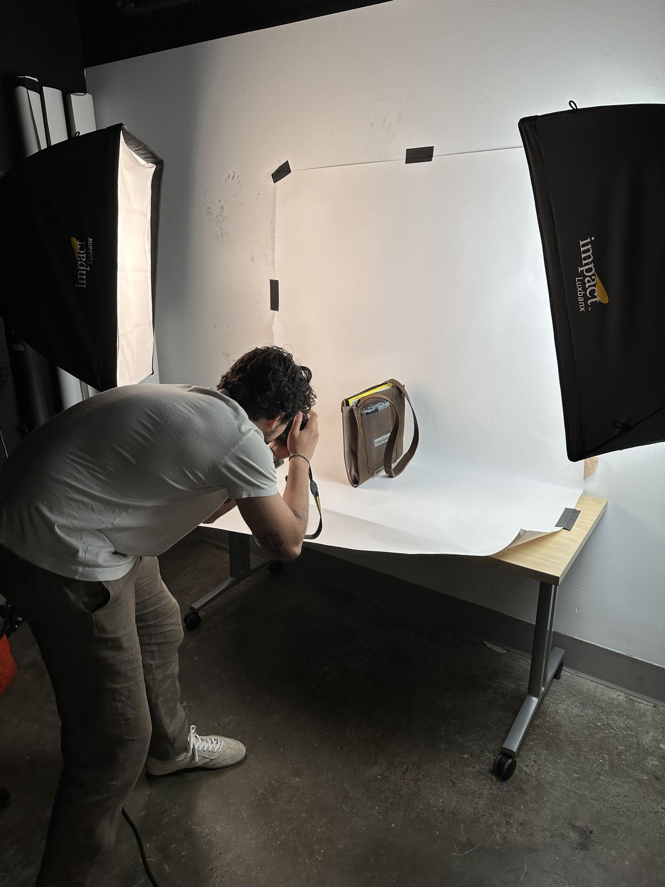 Behind the scenes — wider shoot setup, bag taped to seamless backdrop