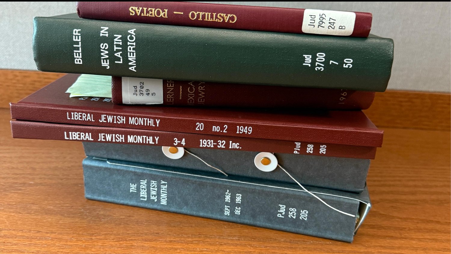 Stack of bound Ladino journals from the Harvard archive