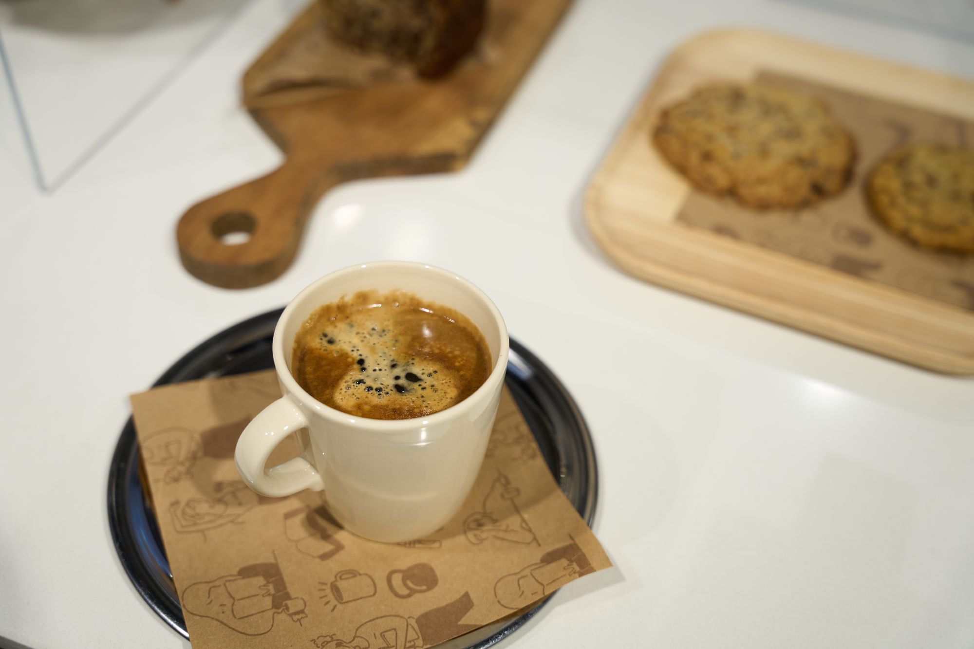 Mom's Club — espresso on branded kraft paper napkin with cookies