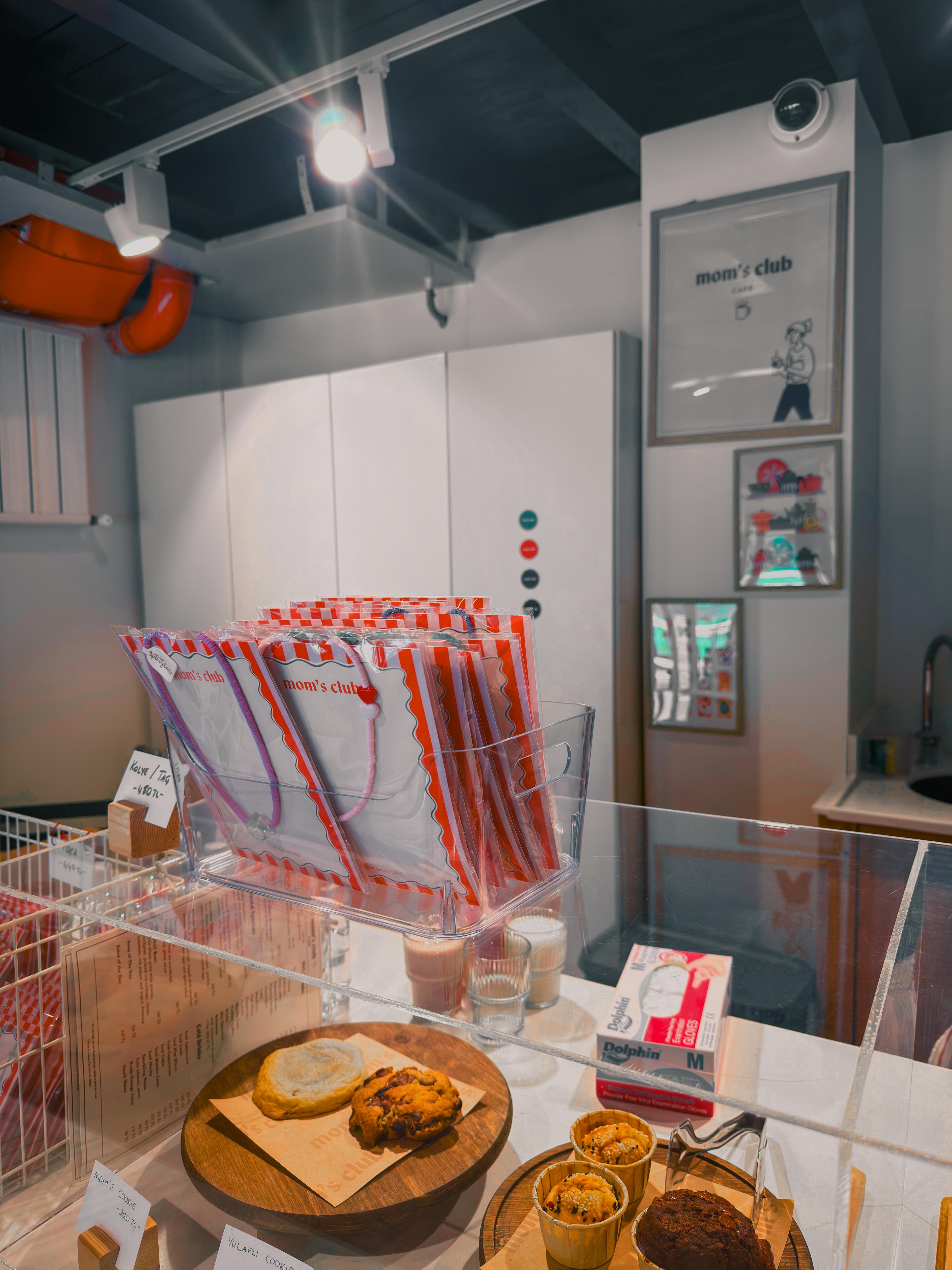 Mom's Club — counter display with branded bags and pastries