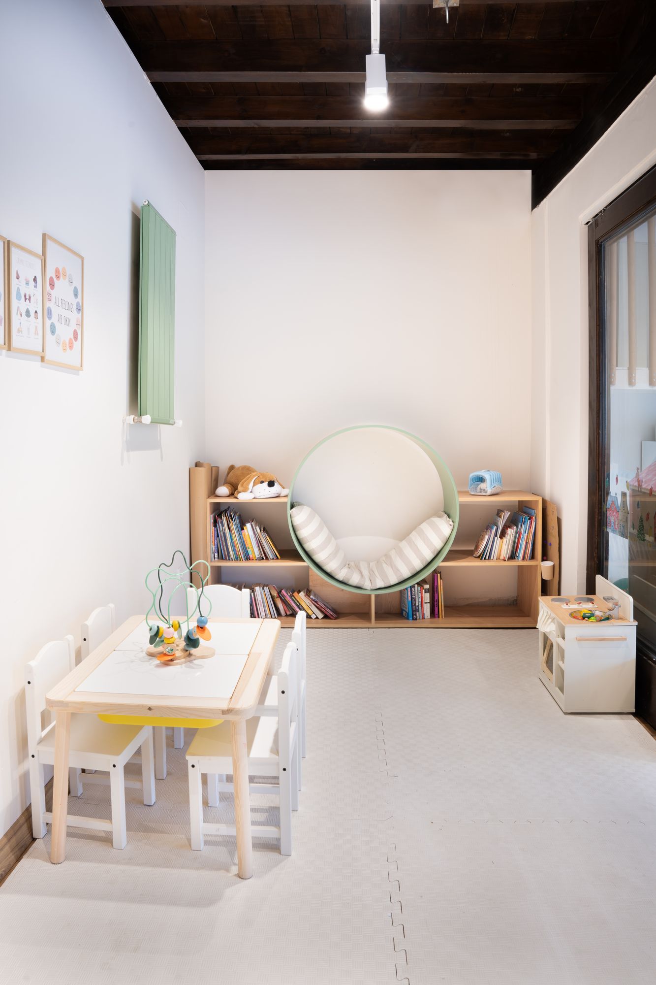 Mom's Club — kids corner with reading nook and activity table